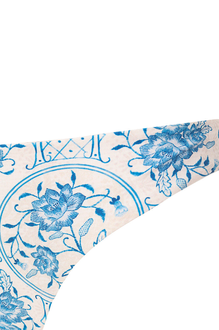 Ilu bikini bottom in blush pink with blue porcelain-inspired pattern detail print featuring ornamental borders and botanical vines