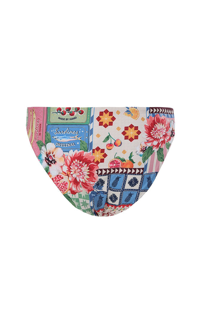 Bikini bottom with patchwork print featuring sardine tin graphics, geometric star patterns, pink florals, pineapple tiles, and fruit illustrations