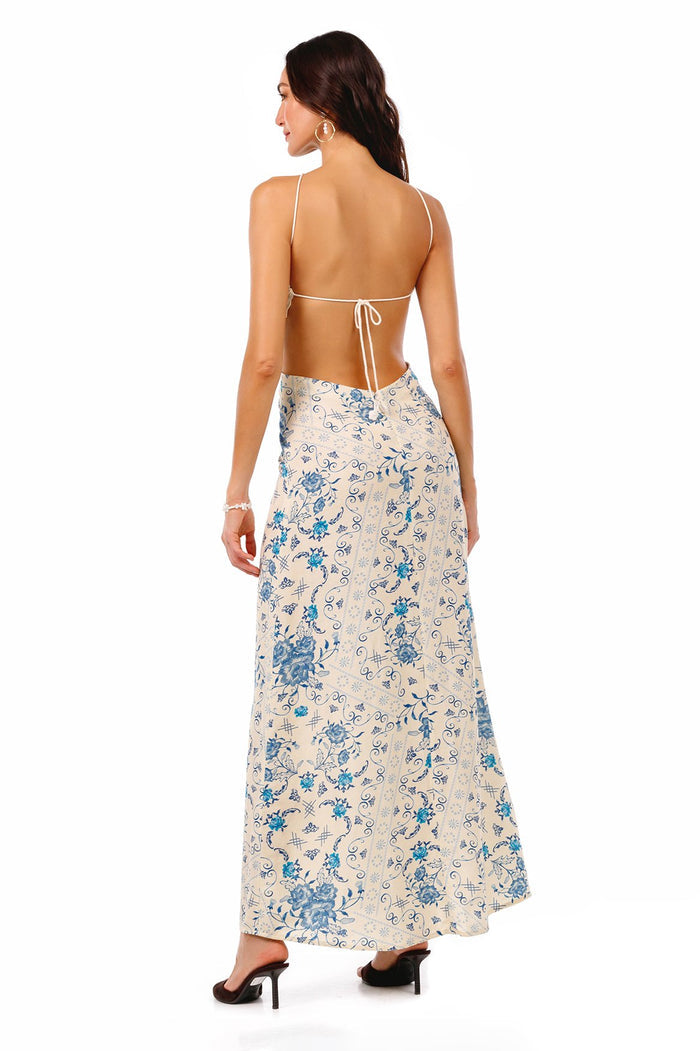 Indira maxi dress in cream with blue pattern detail print, halter neckline, open back with braided straps and tie closure, back view