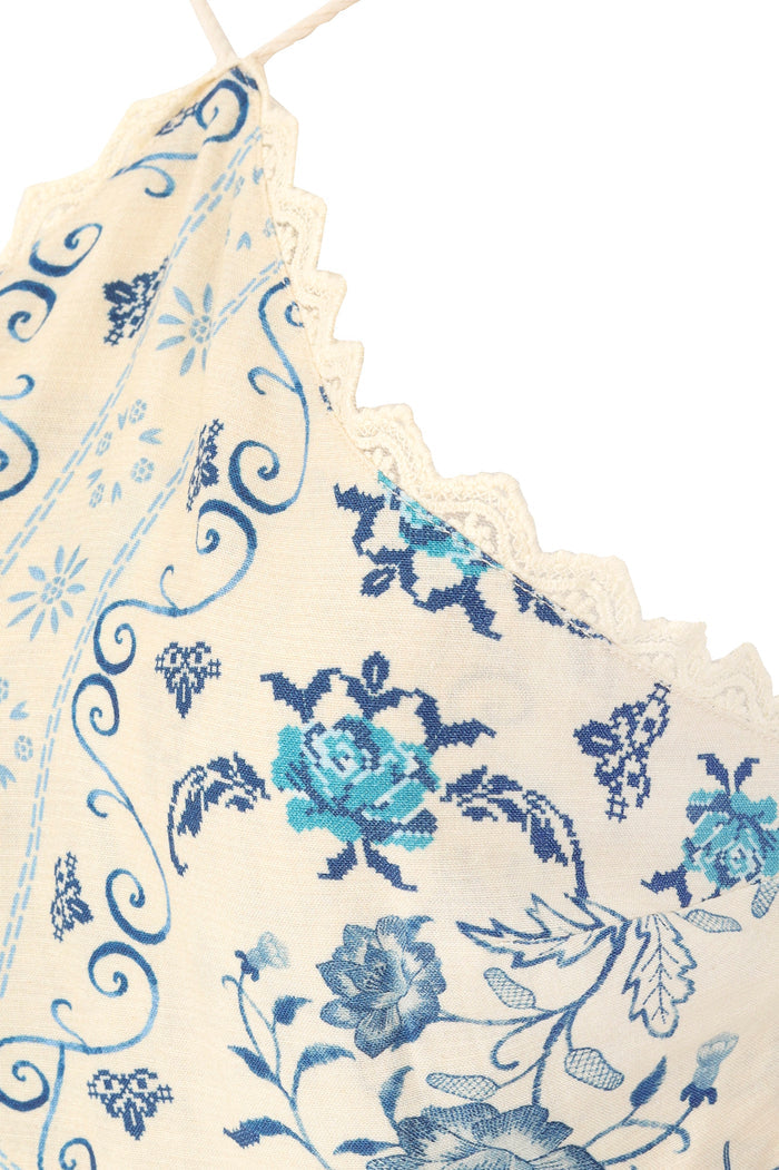Indira halter maxi dress in cream with blue pattern detail print, scalloped lace trim, and braided straps