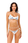 White bikini top with blue floral appliqués, beaded details, and adjustable braided straps
