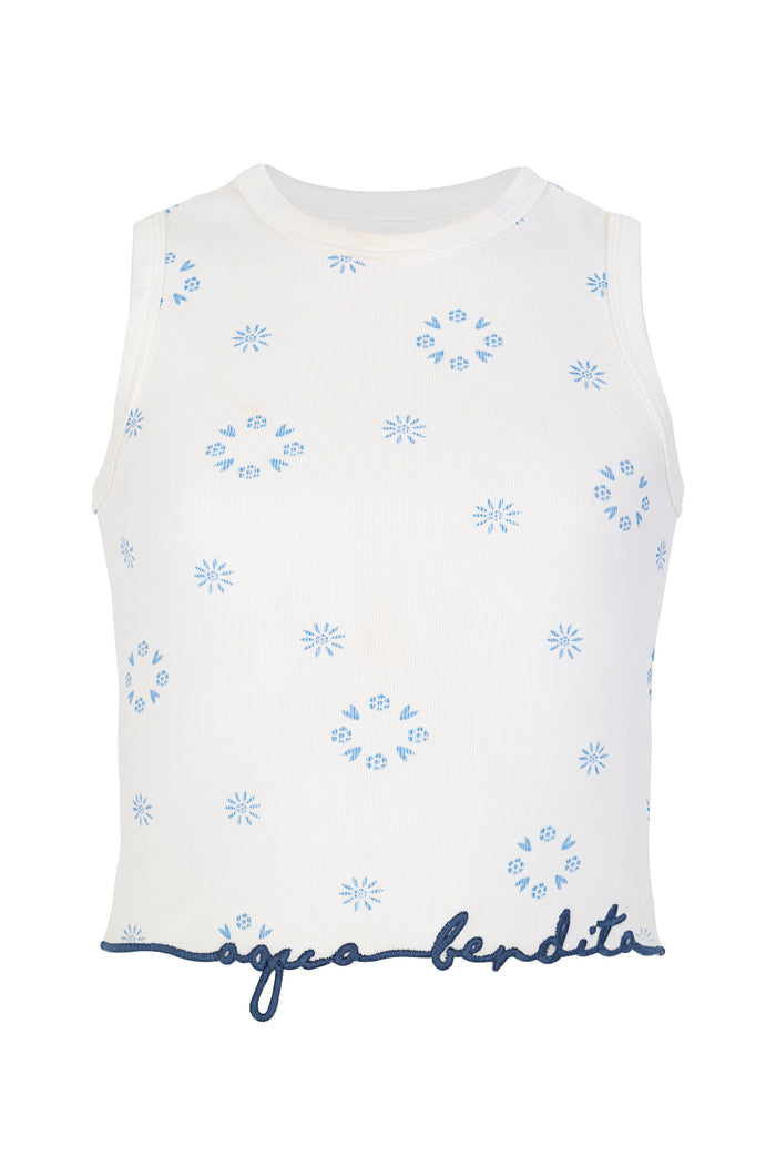 White ribbed sleeveless top with blue embroidered pattern detail and starburst pattern and navy script trim at hem