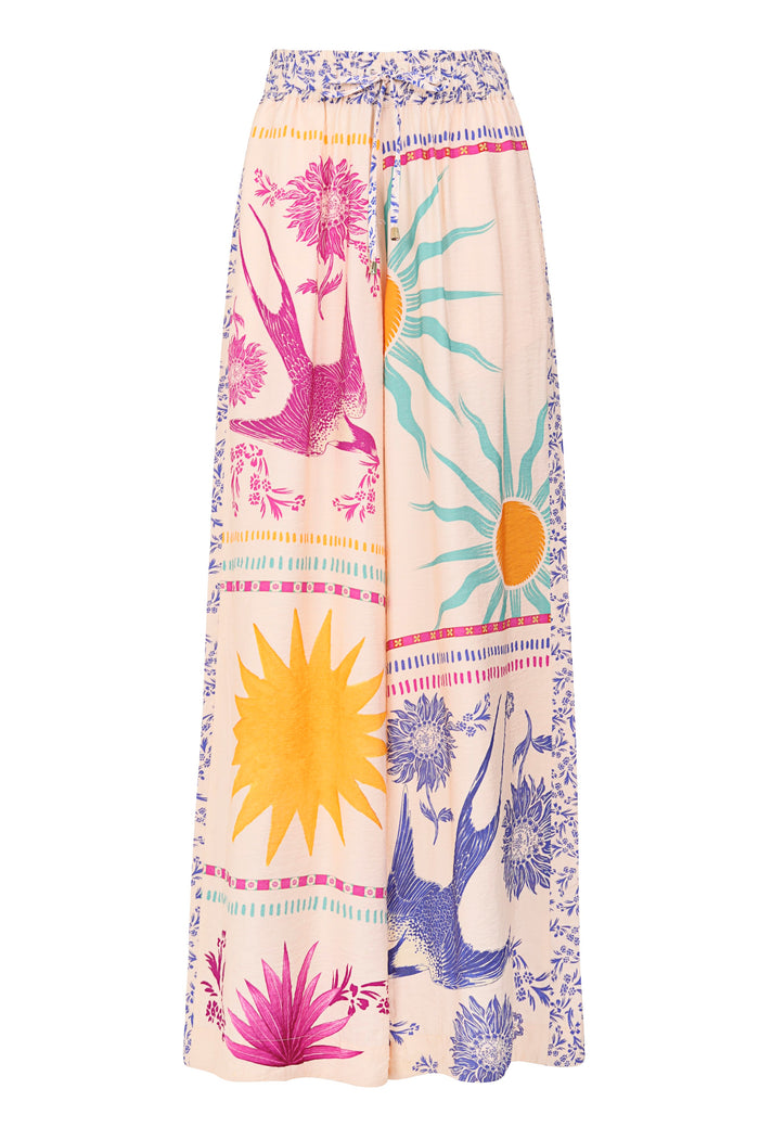 Janis wide-leg pants in peach with multicolored placement print featuring suns, birds, florals, and decorative border stripes