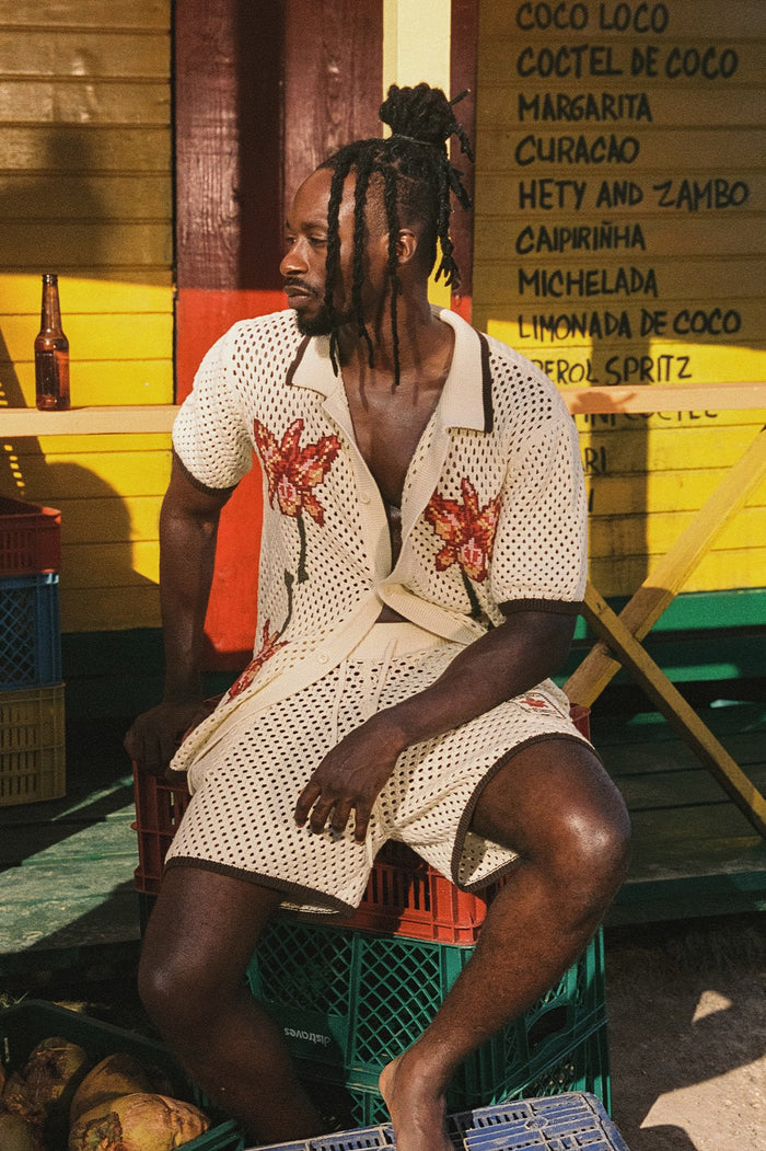 Cream open-knit men's shirt with embroidered pattern detail appliqués on chest and contrast trim detailing