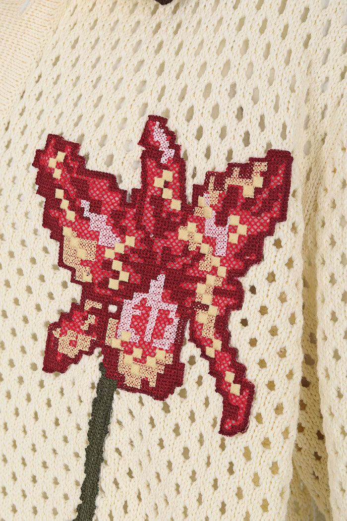 Cream open-knit shirt with sequined red and gold embroidered flower appliqué on front