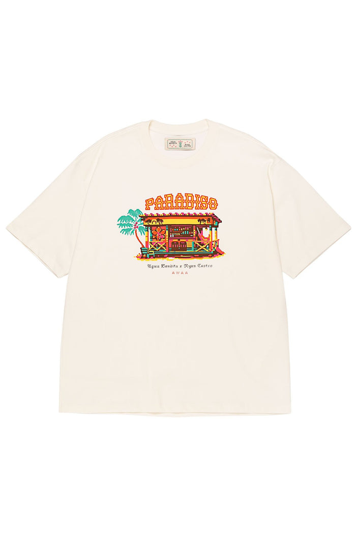 Cream Jhoselyn t-shirt with embroidered paradise scene graphic featuring colorful beach hut, palm trees, and Paradise text in marquee lettering