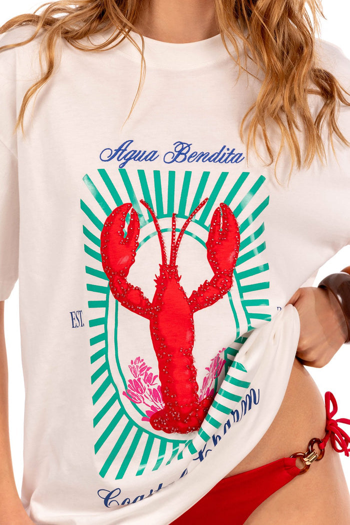 White oversized t-shirt with embroidered red lobster graphic centered on green striped sunburst frame