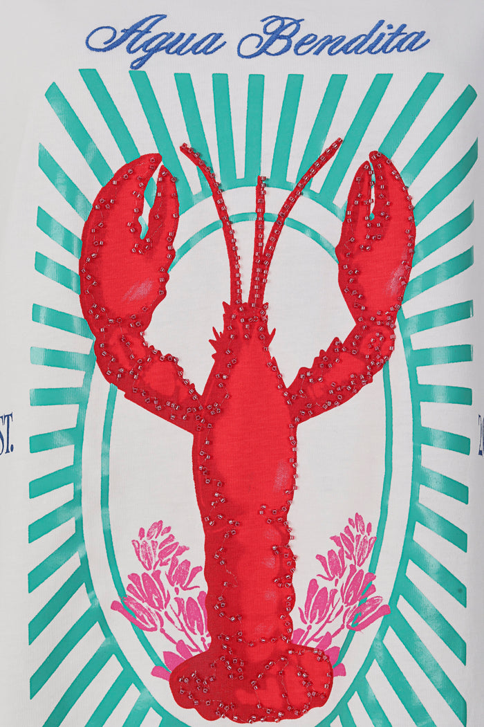White oversized t-shirt with red embroidered lobster and turquoise radiating stripe pattern