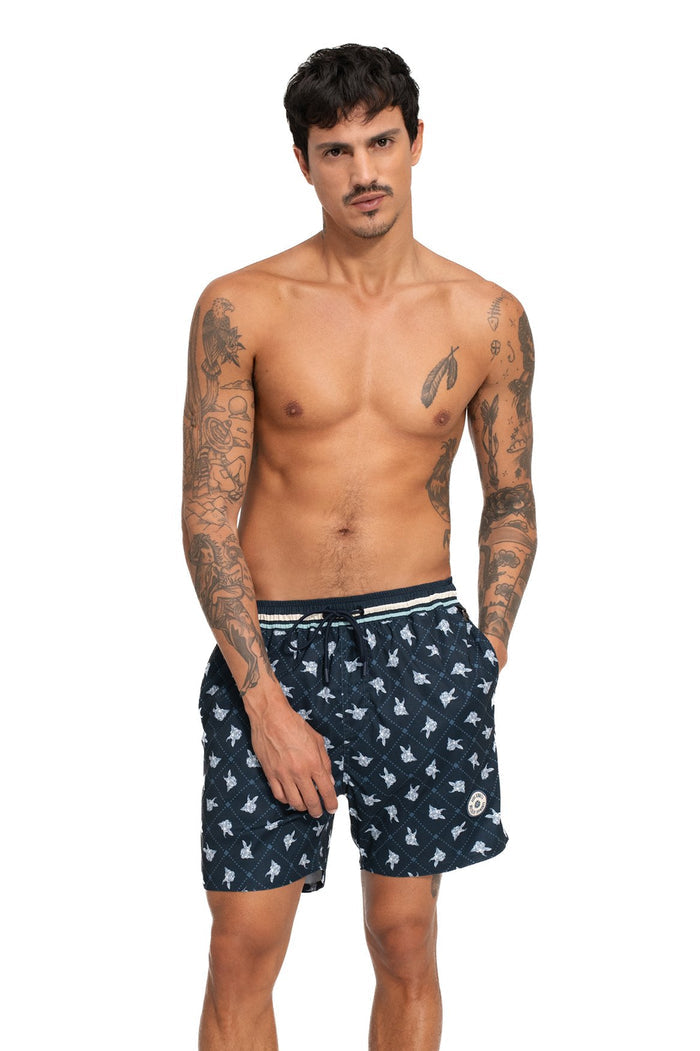 Navy swim trunks with white repeating silhouette print, striped elastic waistband, and side pockets
