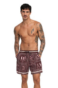 Burgundy men's swim trunks with pink geometric square pattern and embroidered wave details