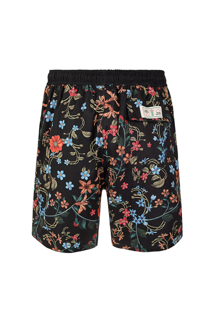 Black swim trunks with multicolor floral embroidery print featuring blue, coral, and pink flowers with green vines and leaves