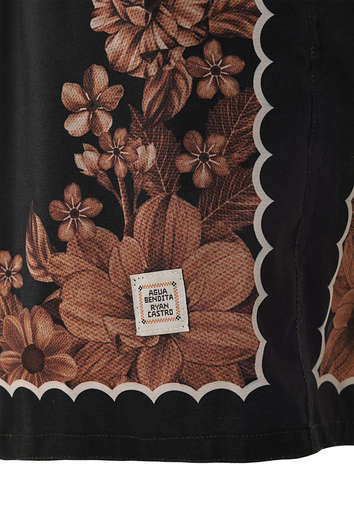 Black swim trunks with brown pattern detail print panel, scalloped cream trim, and side pockets