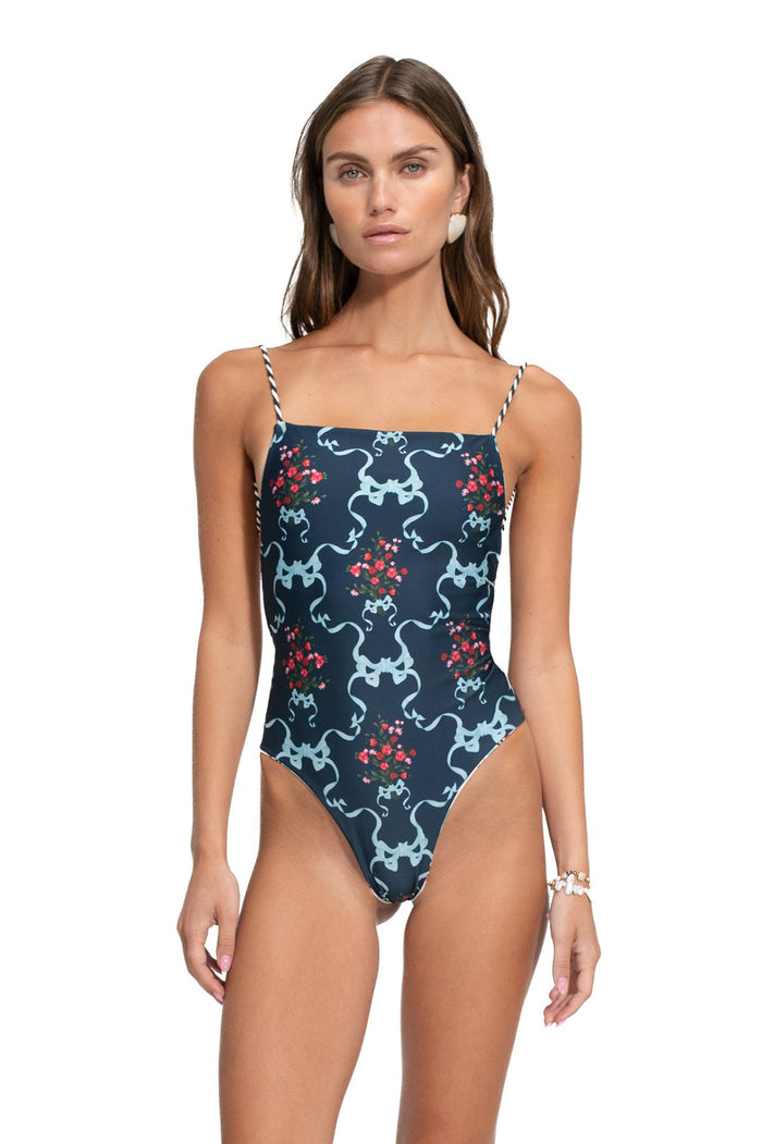 Kali one-piece swimsuit in navy with light blue symmetrical print and red pattern detail clusters, braided adjustable straps