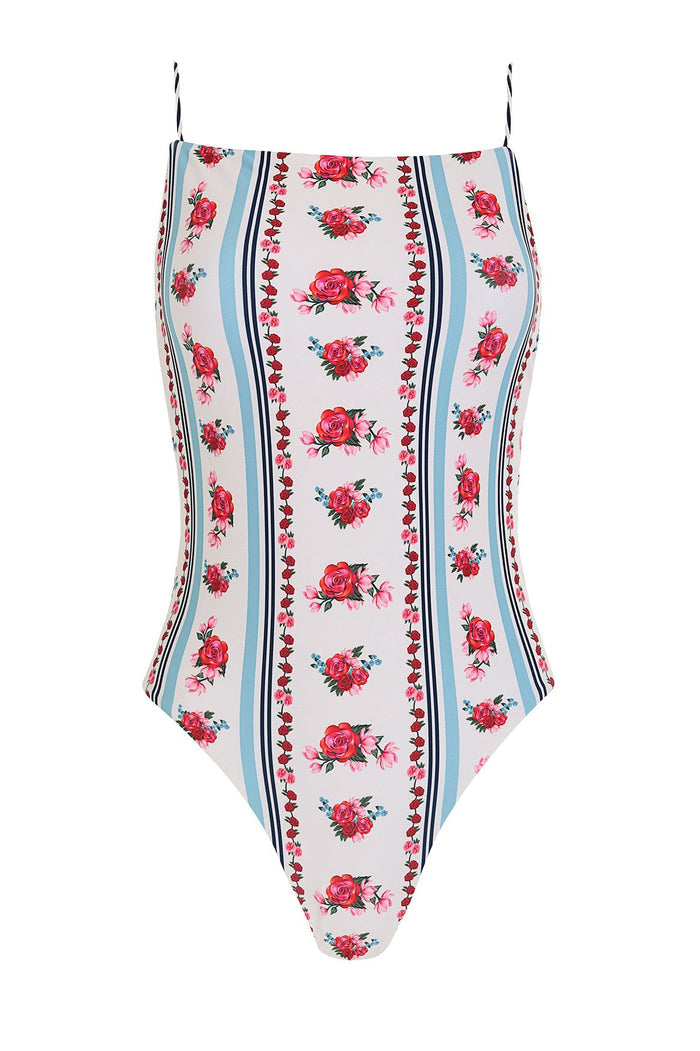 Kali one-piece swimsuit in white with vertical stripes in blue and navy, rose pattern detail print, and braided straps with handmade tie ends