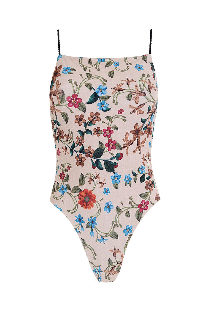 Kali one piece swimsuit in blush pink with pattern detail print featuring blue, coral, and fuchsia blooms and green leaves on braided straps