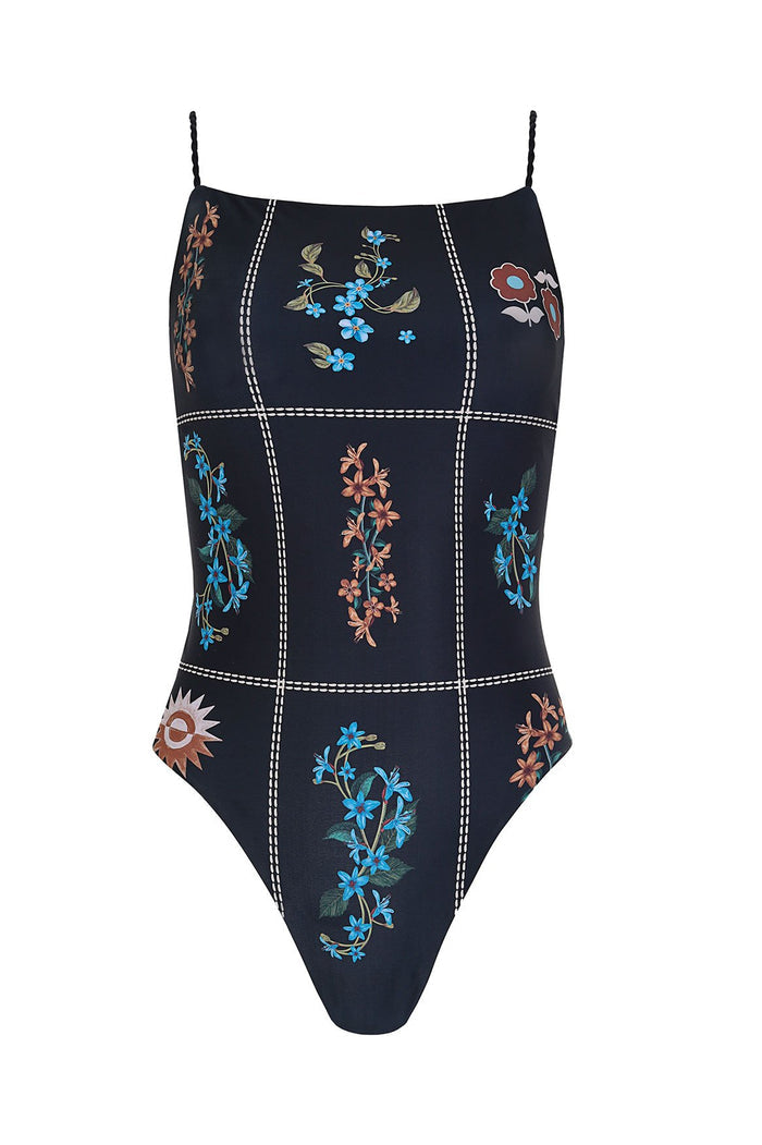 Black one-piece swimsuit with white stitched grid pattern and embroidered pattern detail details in blue, coral, and red tones