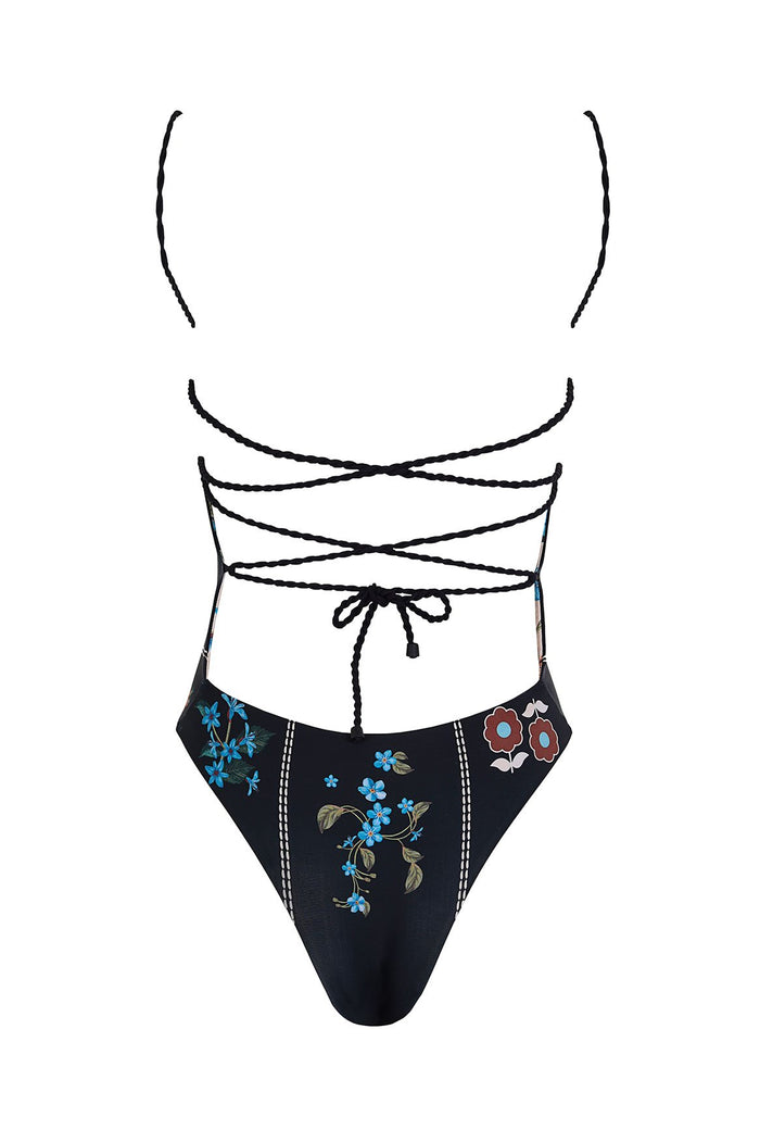 Black one-piece swimsuit with braided lace-up straps, embroidered blue and rust pattern detail pattern with vertical stitch detailing