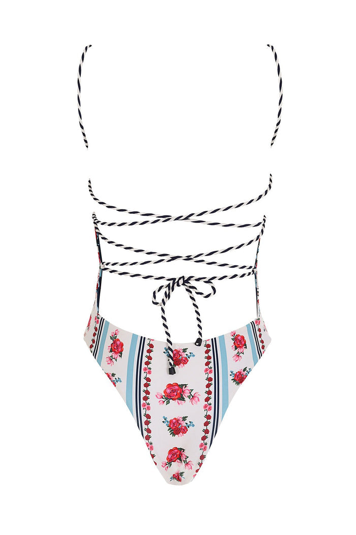 Kali one piece swimsuit in white with vertical blue stripes and pink rose pattern detail print, featuring braided black and white halter straps with…