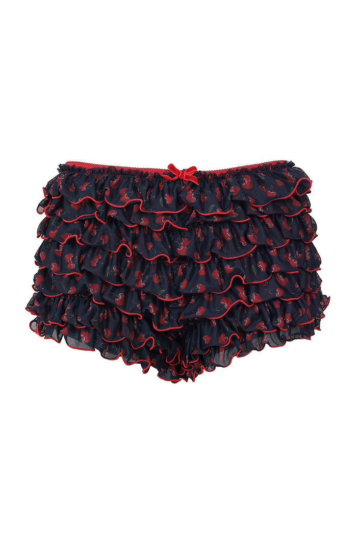 Navy shorts with red curved shapes print and layered ruffle tiers edged in red piping, bow at waistband