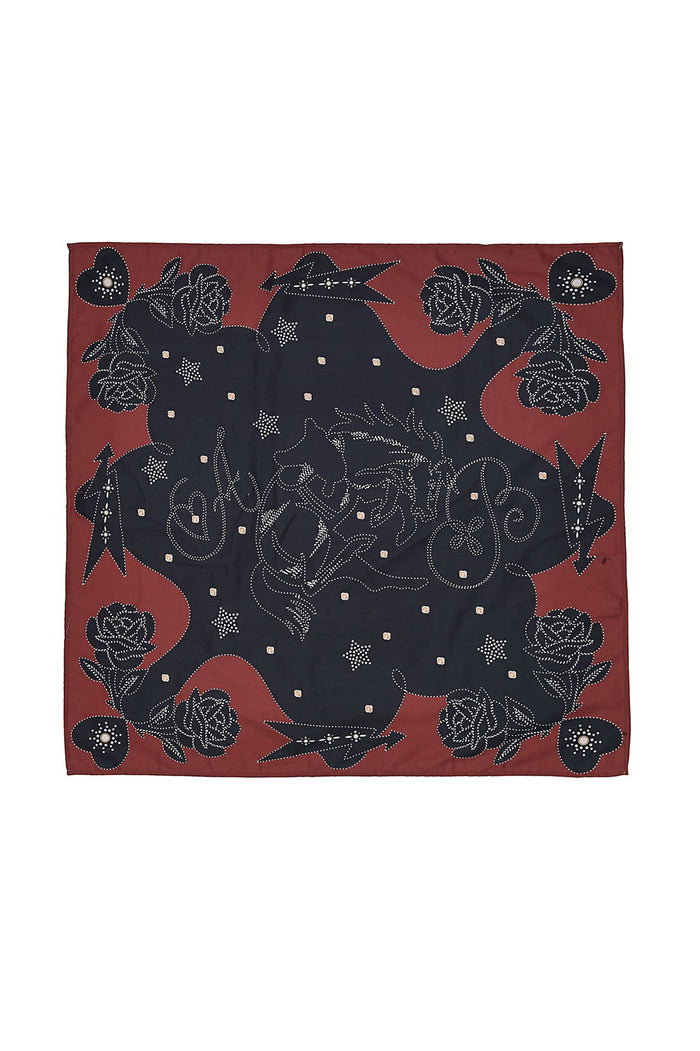 Lexi Scarf in rust and black with dotted western-inspired print featuring roses, stars, and decorative arrows along the border