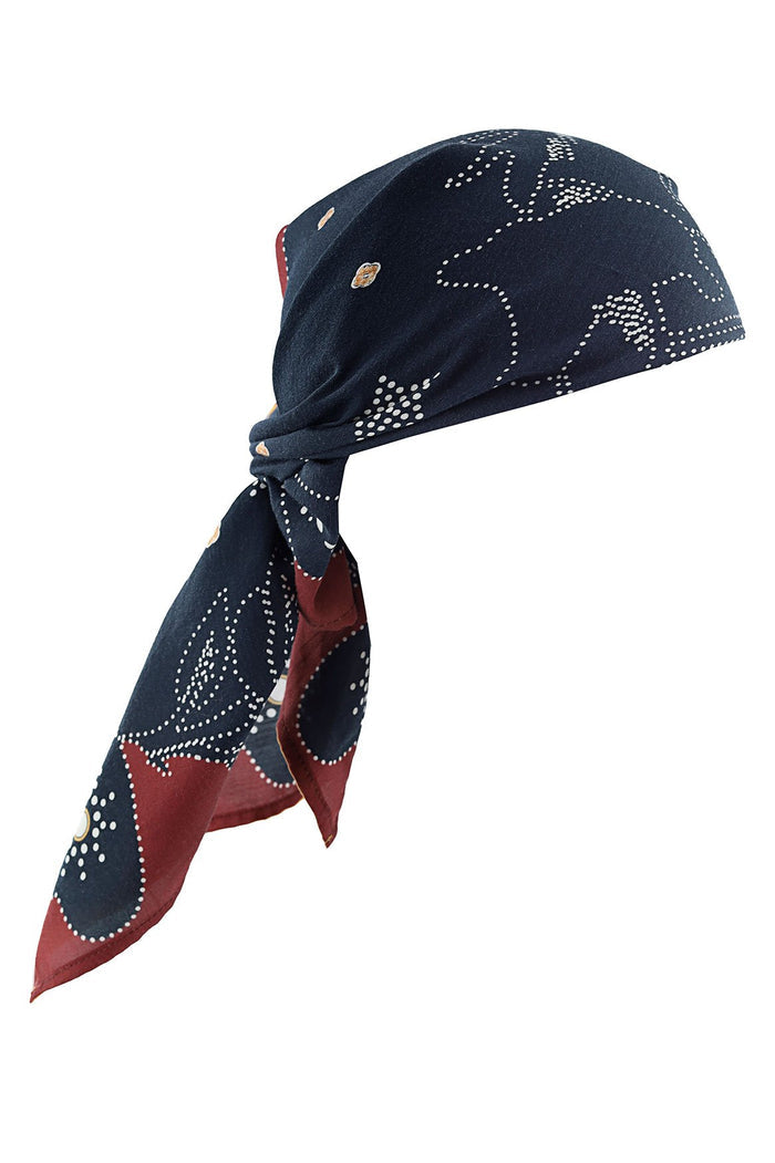 Navy scarf with white dotted curves and burgundy contrast border, tied in bandana style with hardware ring detail
