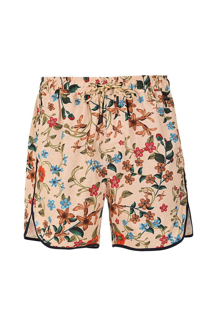Liam men's swim trunks in peach with scattered floral print featuring lilies, small blossoms, and green leaves, black contrast trim