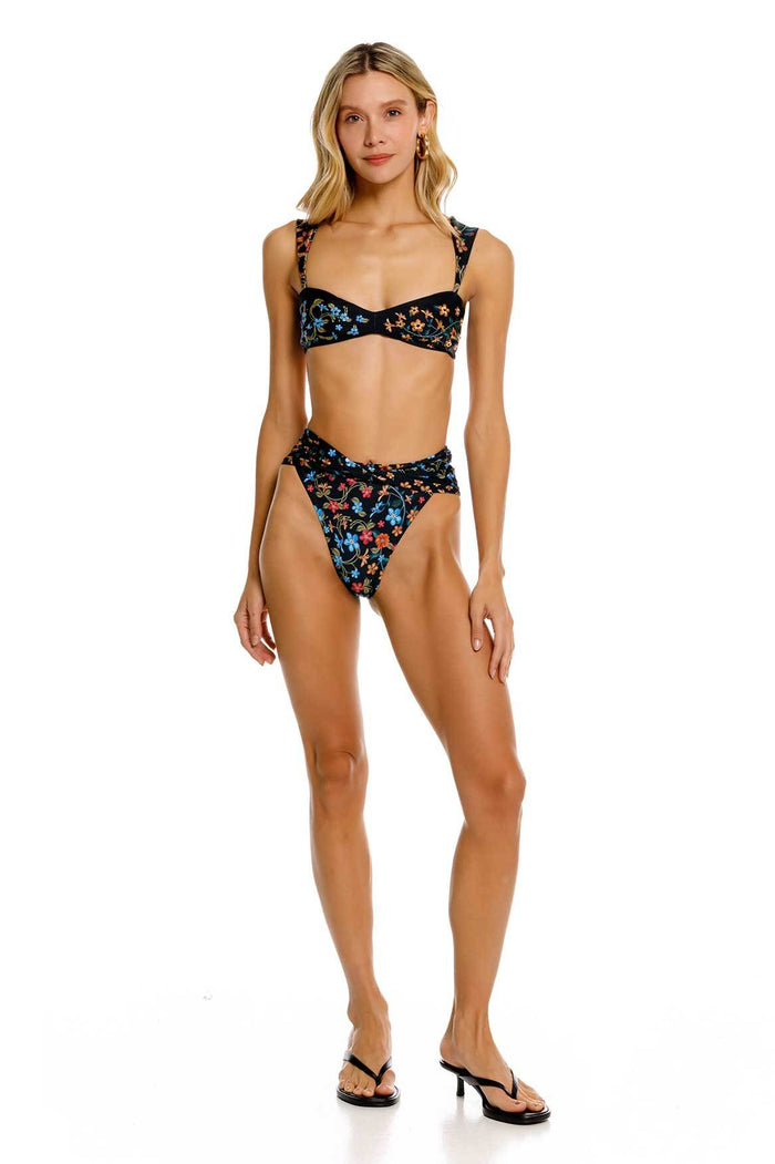 Black bikini bottom with multicolored floral print featuring blue, coral, and pink blooms, high-rise waist with structured front detail