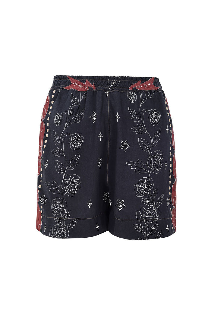 Linny shorts in black with white dotted pattern detail embroidery, rust red side panels with contrast stitching, and elastic waistband