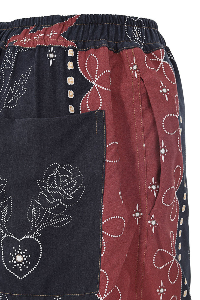 Linny Shorts in navy and terracotta with dotted white embroidery pattern forming pattern detail and geometric outlines, featuring elastic waist and s…