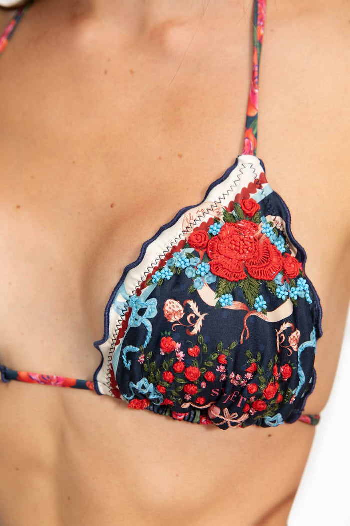 Triangle bikini top with navy pattern detail print, coral hand-embroidered crochet appliqué, scalloped edges with zigzag trim, and multicolor straps
