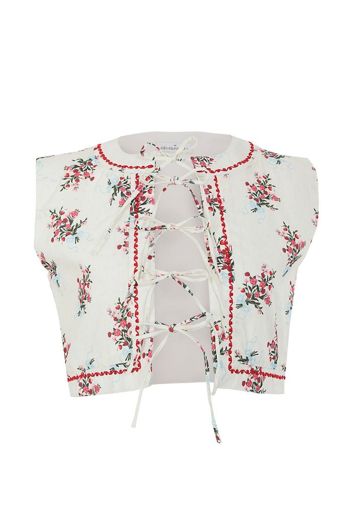 White sleeveless vest with floral print, red scalloped trim, and center lace-up detail