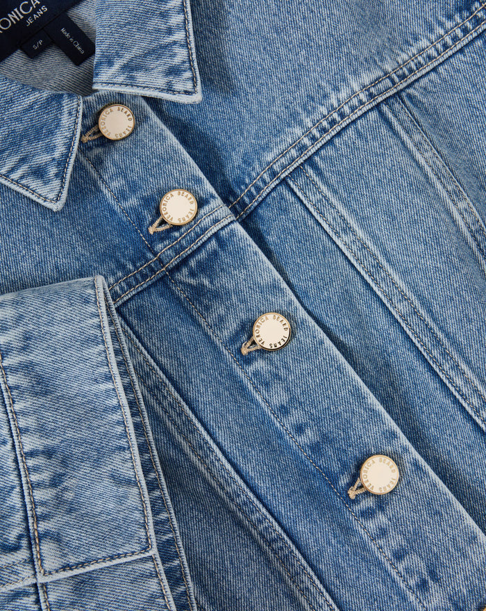 Veronica Beard Light wash denim short-sleeve button-up shirt and matching mini skirt.