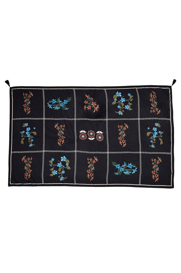 Black pareo with grid pattern featuring embroidered blue and coral pattern detail details and tasseled corners