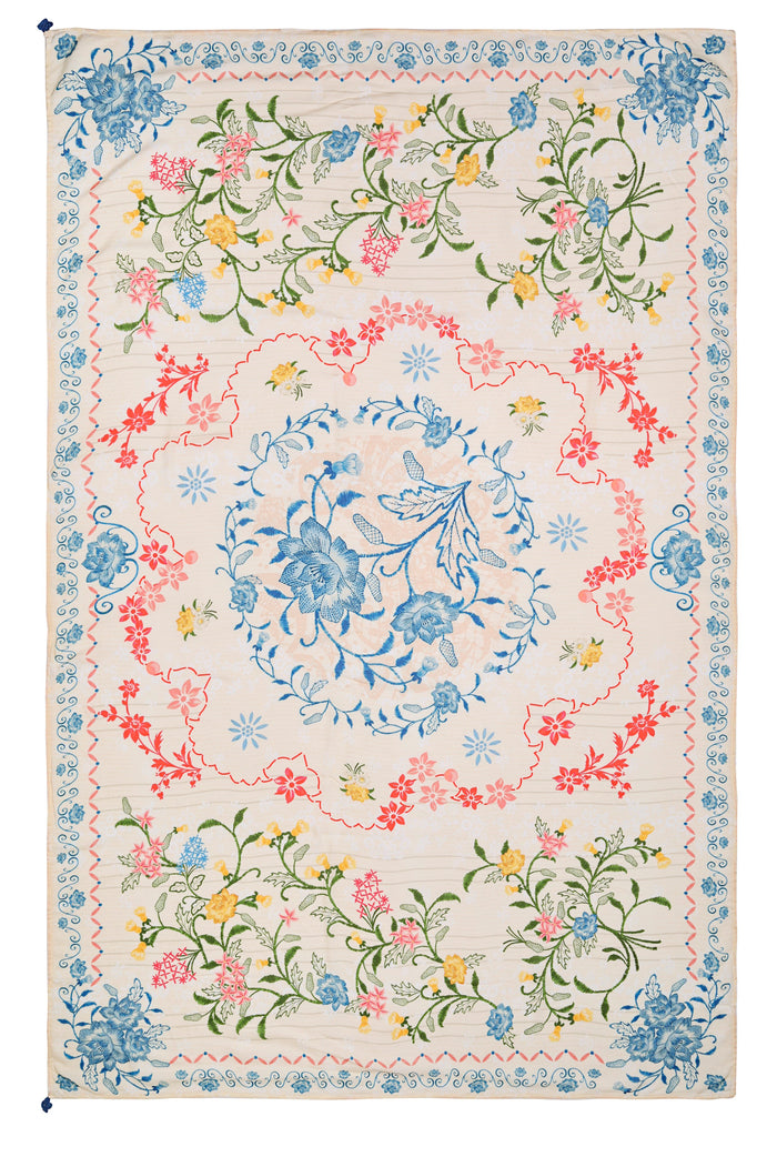 Marine pareo cover-up with cream base and embroidered botanical print featuring blue pattern detail centerpiece, coral and pink flowers, green vines,…