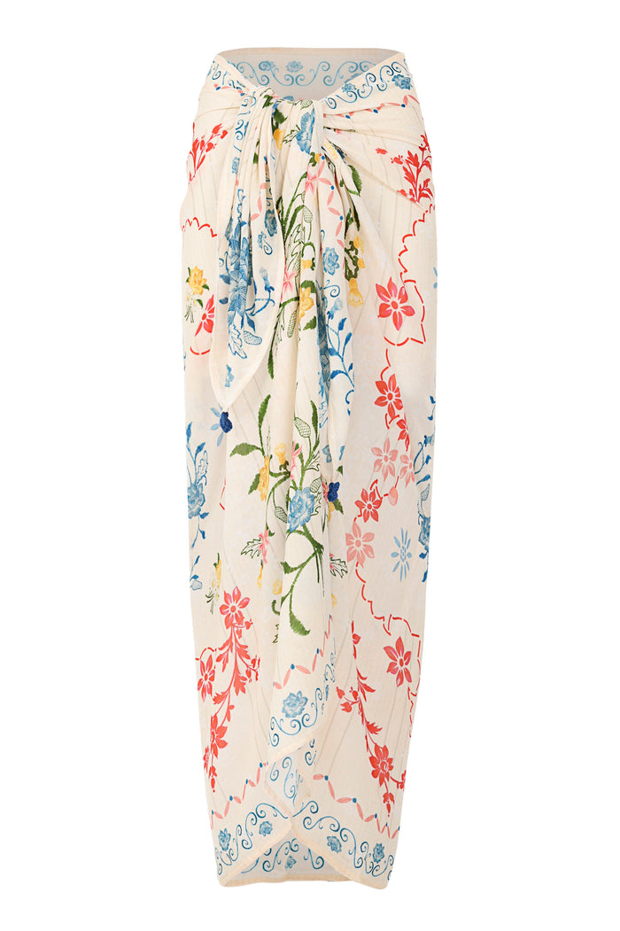 Cream pareo cover-up with multicolor pattern detail embroidery featuring blue scrollwork, coral and pink blooms, and green stems with handmade croche…