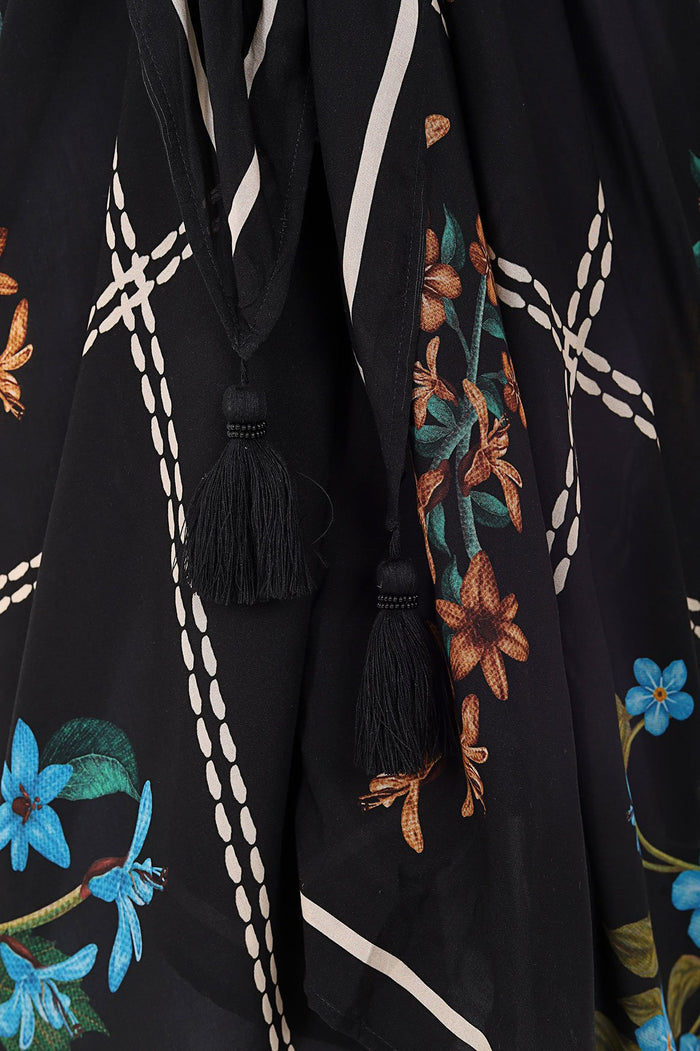 Black pareo with pattern detail print, white dotted trim, and black tassels at corners