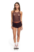 Black mesh tankini with red cherry print and scalloped trim, paired with ruffled swim shorts