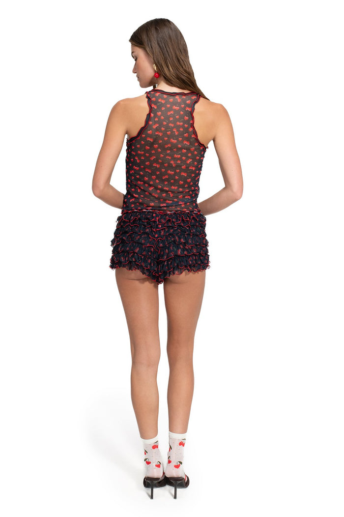 Black mesh racerback crop top with red cherry print and matching ruffled shorts, back view