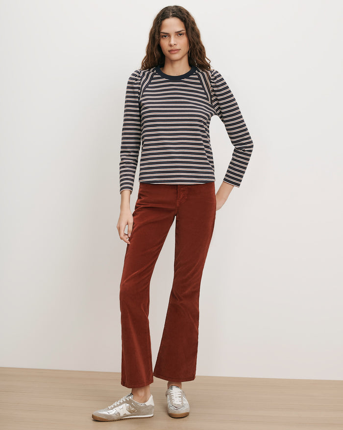 Veronica Beard Navy and white striped long-sleeve shirt, rust corduroy pants.