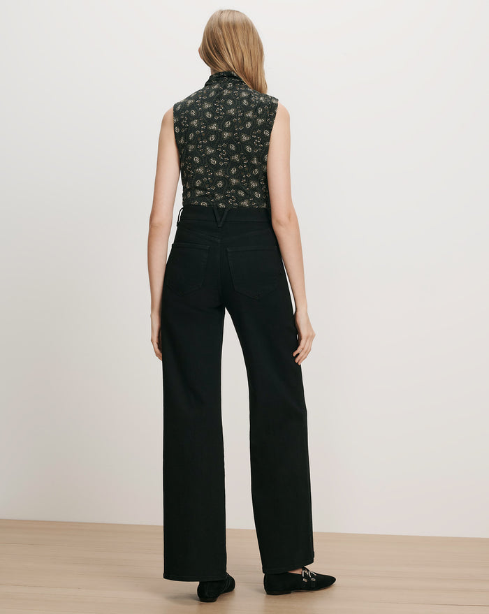 Veronica Beard Black floral sleeveless top and black wide-leg jeans.