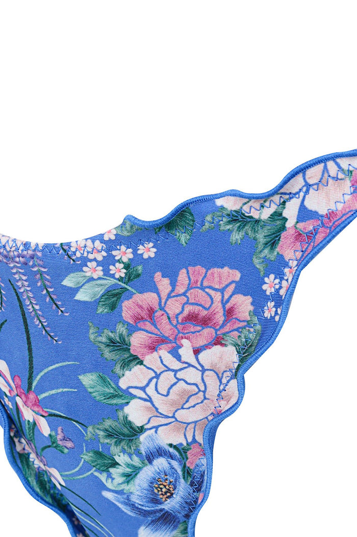 Nader Alegria bikini bottom in vibrant blue with pink and white pattern detail print, scalloped trim with ruched detailing and adjustable side ties