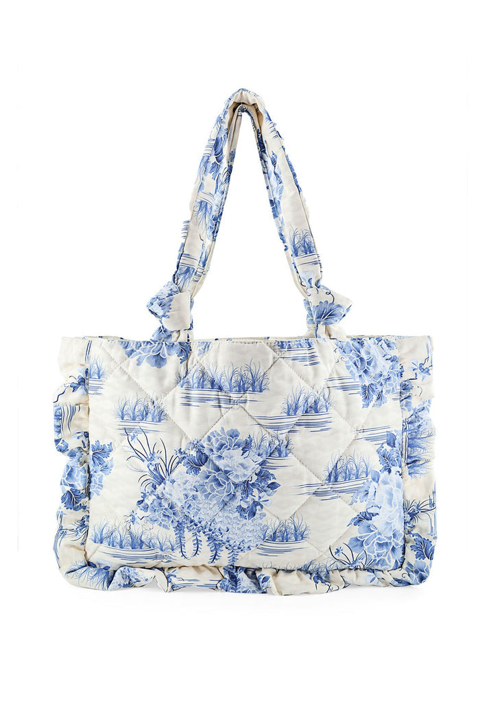 Quilted tote bag in cream with blue pattern detail print, knotted handles, and ruffle trim edges