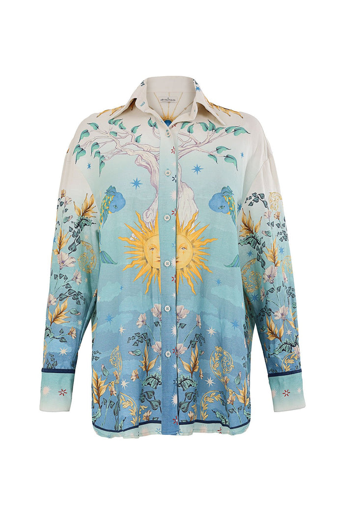 Nader Anastasia Shirt with ombré blue to cream gradient, celestial print featuring sun emblems, stars, tree silhouettes, and botanical elements throu…