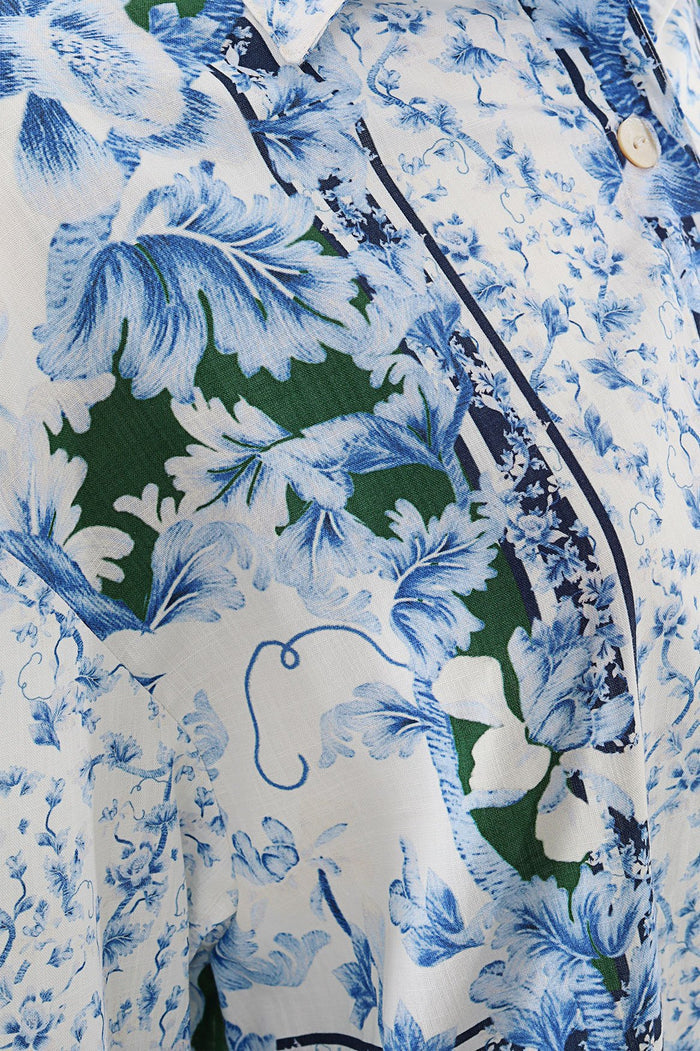 White shirt with blue and green pattern detail print featuring long sleeves and button closure