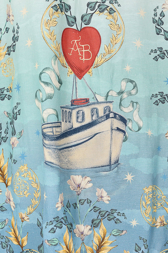Light blue shirt with placement print featuring boats, red hearts, golden wreaths, and botanical elements