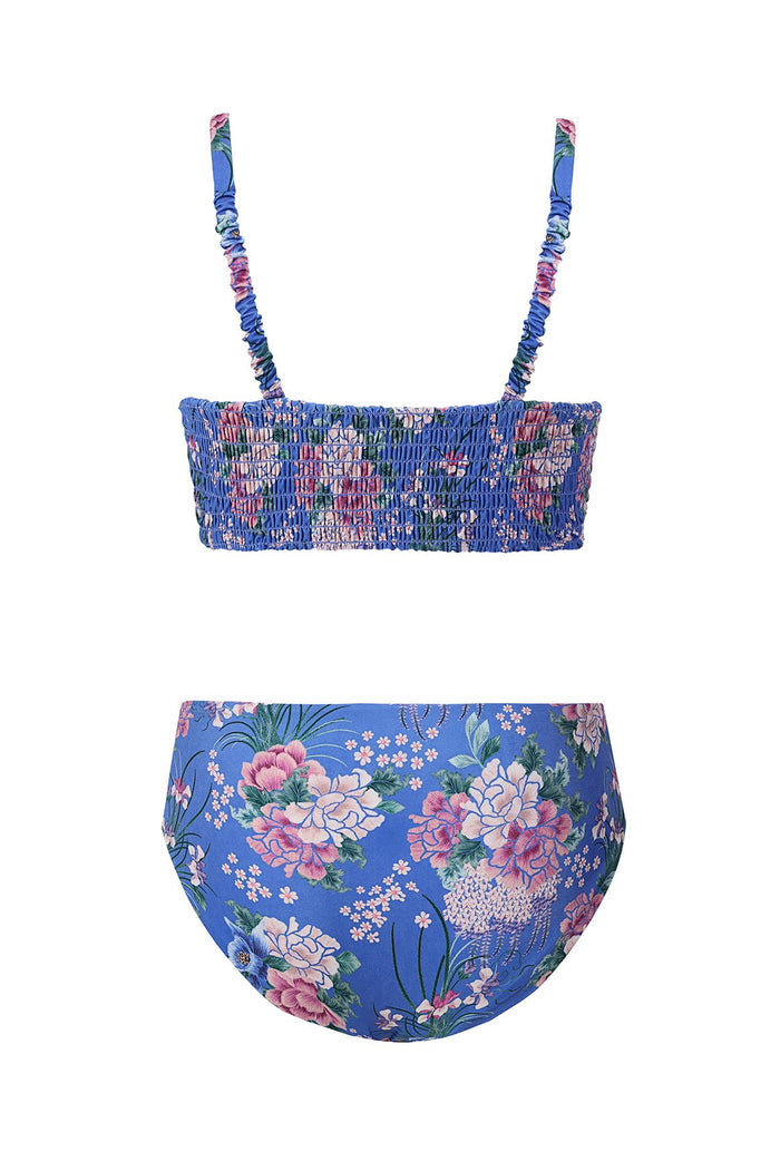 Blue bikini set with pink and white pattern detail print, smocked bandeau top with ruched straps and matching mid-rise bottom