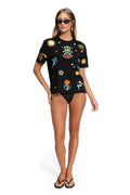 Black short-sleeve t-shirt with embroidered sun, star, and heraldic emblem details throughout