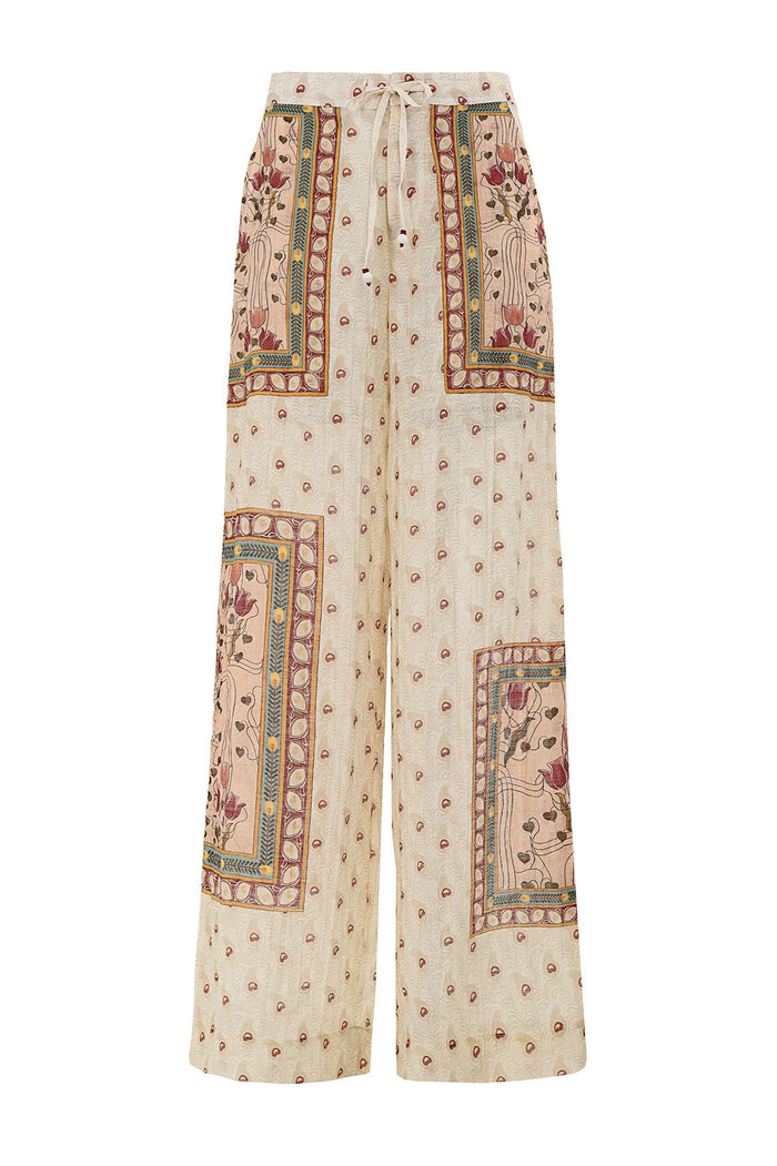 Wide-leg pants in cream with scattered dots and framed panels featuring pattern detail embroidery and decorative borders, elastic waist with lace tie