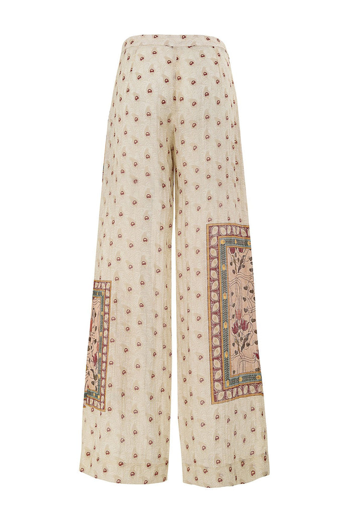 Wide-leg pants in cream with scattered brown polka dots and contrasting pattern detail embroidered panels at lower legs