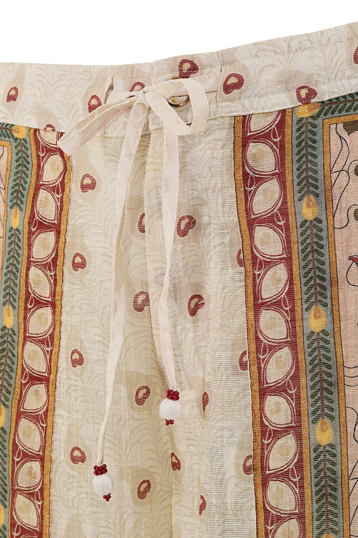 Nader Caroline Pants in cream with vertical stripes featuring red paisley dots, geometric borders in rust, gold and teal, elastic waist with adjustab…